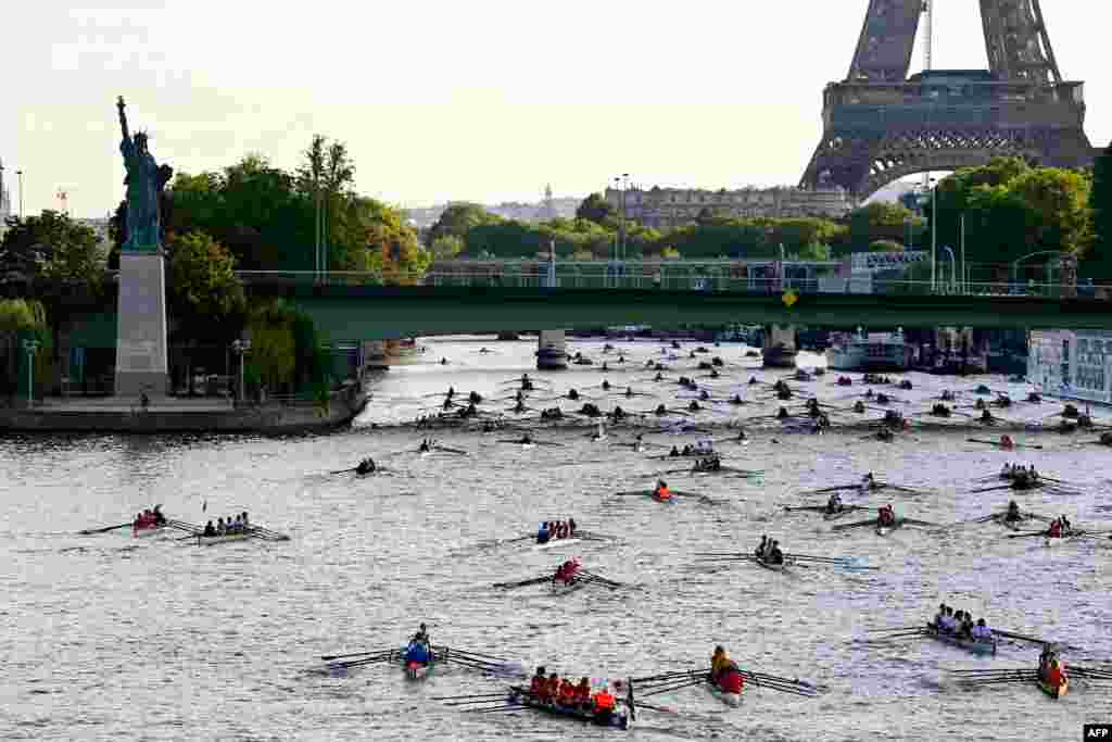 Nearly 1000 rowers, in some 230 boats, scull towards the Eiffel Tower as they participate in the 37th edition of 'La Traversee de Paris en Aviron' along the River Seine, which flows through the center of Paris, France.