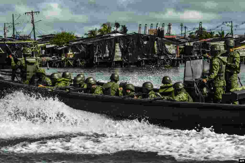 Members of the Colombian Navy patrol on a boat in Buenaventura, Sept. 3, 2022. Most of Buenaventura is controlled by local gangs that dispute the territory with violence and illegal economies like drug trafficking and extorsion.