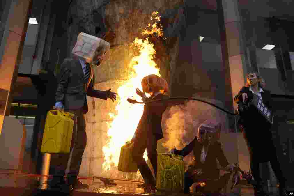 Ocean Rebellion demonstrators protest outside the International Maritime Organization against the use of fossil fuels in the shipping industry, in London.