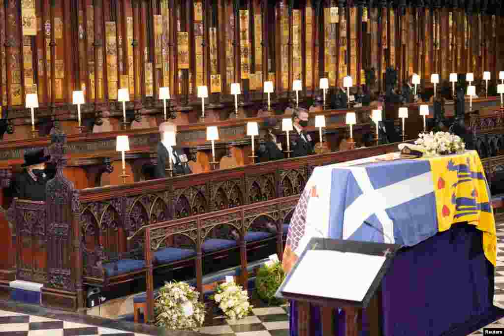 Queen Elizabeth II looks at the coffin of her husband, Britain's Prince Philip, who died at the age of 99, during his funeral service at St George's Chapel, in Windsor, April 17, 2021.