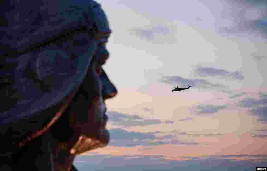 A Russian military helicopter flies near the reconstructed World War Two memorial Savur-Mohyla before its official reopening in the course of Russia-Ukraine conflict in the Donetsk region, Ukraine, Sept. 8, 2022.