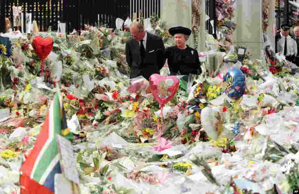 Britain's Queen Elizabeth II and Prince Philip view the floral tributes to Diana, Princess of Wales, at London's Buckingham Palace, Sept. 5, 1997.