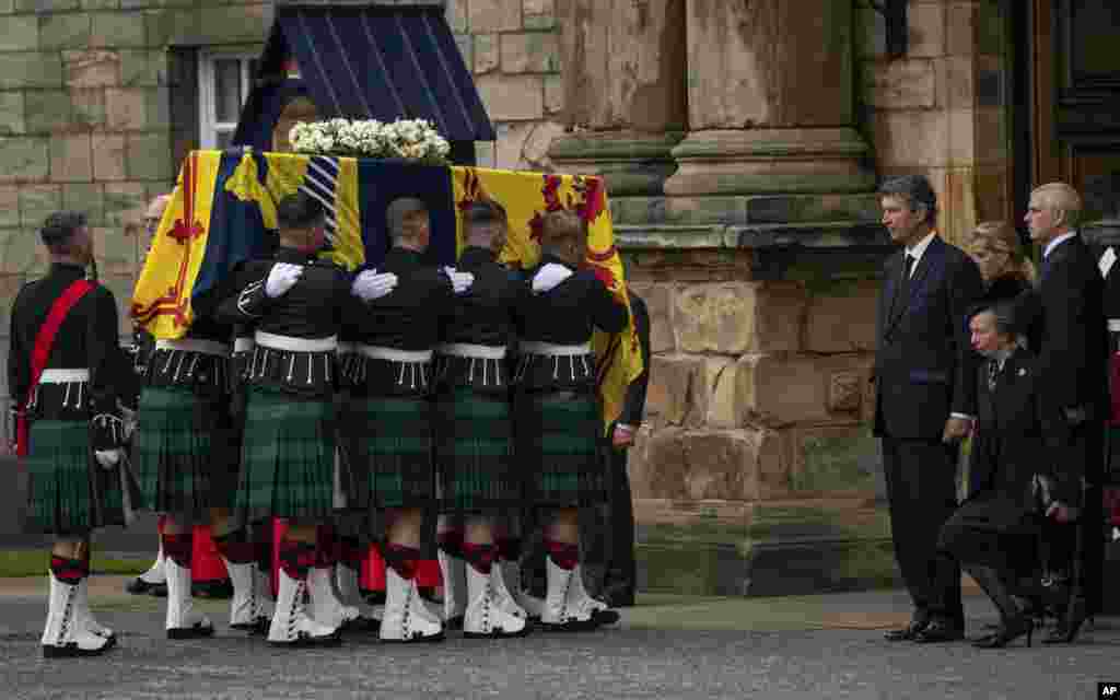 From 2nd right, Vice Admiral Timothy Laurence, Princess Anne, Prince Andrew and Sophie, Countess of Wessex watch as the coffin of Queen Elizabeth II, draped with the Royal Standard of Scotland, completes its journey from Balmoral to the Palace of Holyroodhouse, where it will lie in rest for a day, in Edinburgh. 