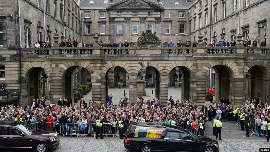 Crowds watch the cortege carrying the coffin of Britain's Queen Elizabeth in Edinburgh, Scotland, Sept. 11, 2022.