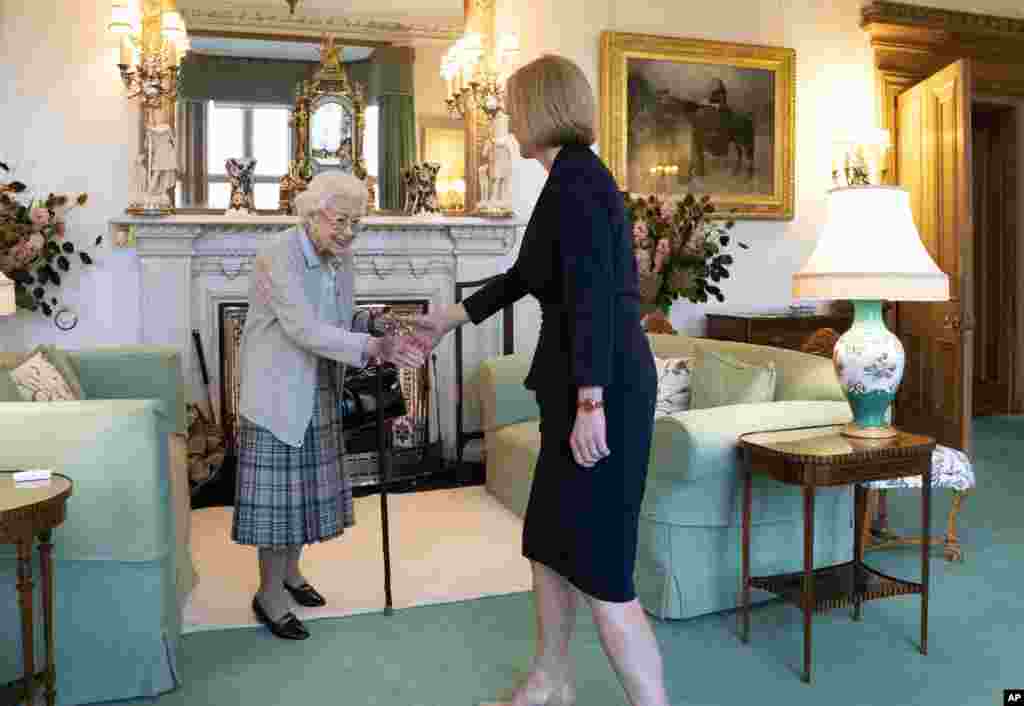 Britain's Queen Elizabeth II, left, welcomes Liz Truss during an audience at Balmoral, Scotland, where she invited the newly elected leader of the Conservative party to become Prime Minister and form a new government.