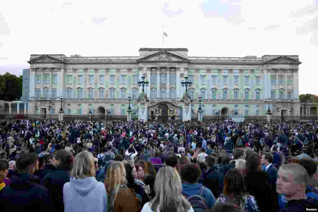People gather outside the Buckingham Palace in London, after Queen Elizabeth, Britain's longest-reigning monarch and the nation's figurehead for seven decades, died, Sept. 8, 2022.