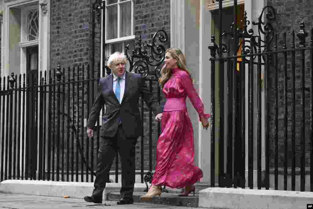 Britain's outgoing Prime Minister Boris Johnson and his wife Carrie come out of 10 Downing Street in London, to deliver a speech before heading to Balmoral in Scotland, where he will announce his resignation to Britain's Queen Elizabeth II.