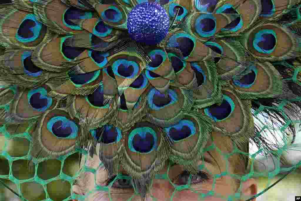 Clair Frank wears a peacock themed hat on the first day of the Royal Ascot horse race meeting at Ascot, England.