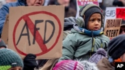 FILE - People protest against right-wing extremism in Frankfurt/Main, Germany, Jan. 20, 2024. Germany’s president has called for a broad “alliance against extremism” in the wake of a report about far-right discussions of deporting millions of immigrants.