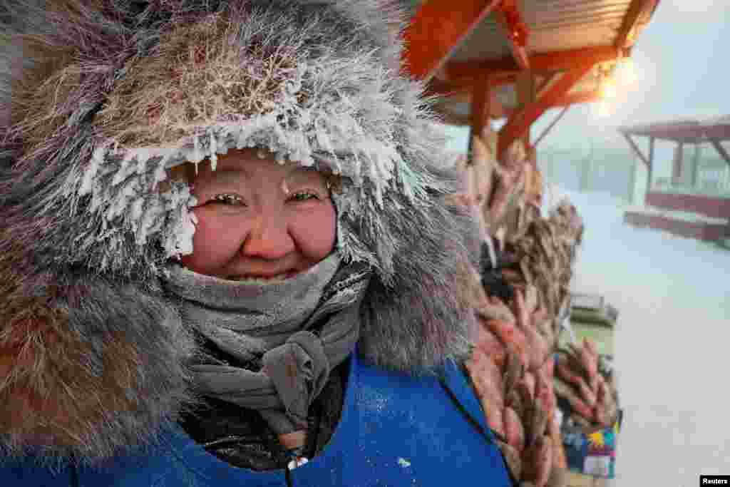Vendor Nyurgusun Starostina, 47, poses for a picture at an open-air market on a frosty day in Yakutsk, Russia. Temperatures in parts of the Sakha Republic, also known as Yakutia and located in the northeastern part of Siberia, went below - 50° C (- 58° F).