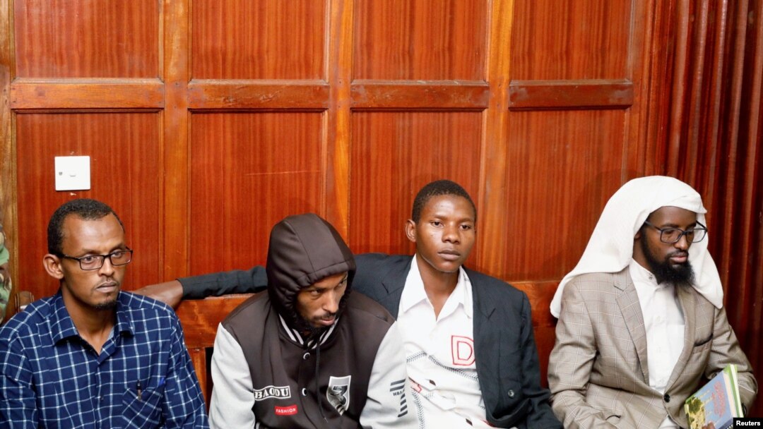 FILE - Suspects Hassan Edin Hassan, Mohamed Abdi Abikar, Rashid Charles Mberesero and Sahal Diriye sit in the dock as they wait for the verdict where they were charged with helping those who carried out the attack on Garissa University, June 19, 2019.