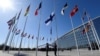 FILE - Finnish military personnel hoist the Finnish national flag at the NATO headquarters in Brussels, as Finland became the 31st member of NATO April 4, 2023.