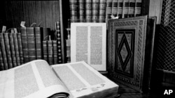FILE - Two volumes of the over 500-year-old Gutenberg Bible are shown in New York in 1978. Johannes Gutenberg planned on printing 150 Bibles, but increasing demand motivated him to produce 30 extra copies, a total of 180. Around 48 complete "Gutenberg Bibles" are preserved.