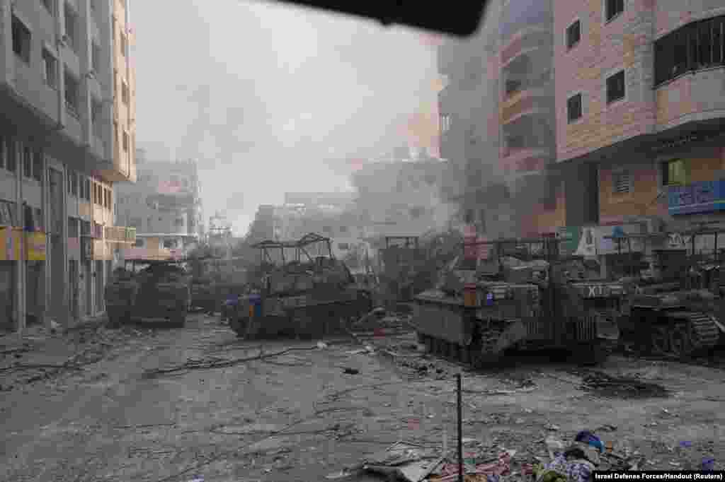 Israeli military vehicles maneuver during the ongoing ground operation of the Israeli army against Palestinian Islamist group Hamas, in the Gaza Strip.