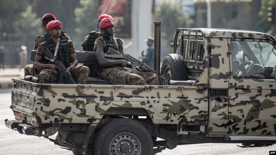 FILE - Security forces ride on the back of a pick-up truck in Addis Ababa, Ethiopia, June 5, 2022. Ethiopian authorities have arrested three journalists since introducing a new state of emergency in August.