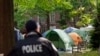 A George Washington University police officer scans the area as students demonstrate on campus during a pro-Palestinian protest against the Israel-Hamas war, April 26, 2024, in Washington. 