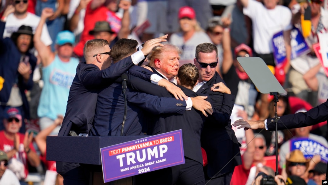 FILE - Republican presidential candidate and former President Donald Trump is helped off the stage at a campaign event in Butler, Pennsylvania, July 13, 2024. 