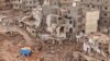 Rescuers and relatives of victims set up tents in front of collapsed buildings in Derna, Libya, Sept. 18, 2023. 