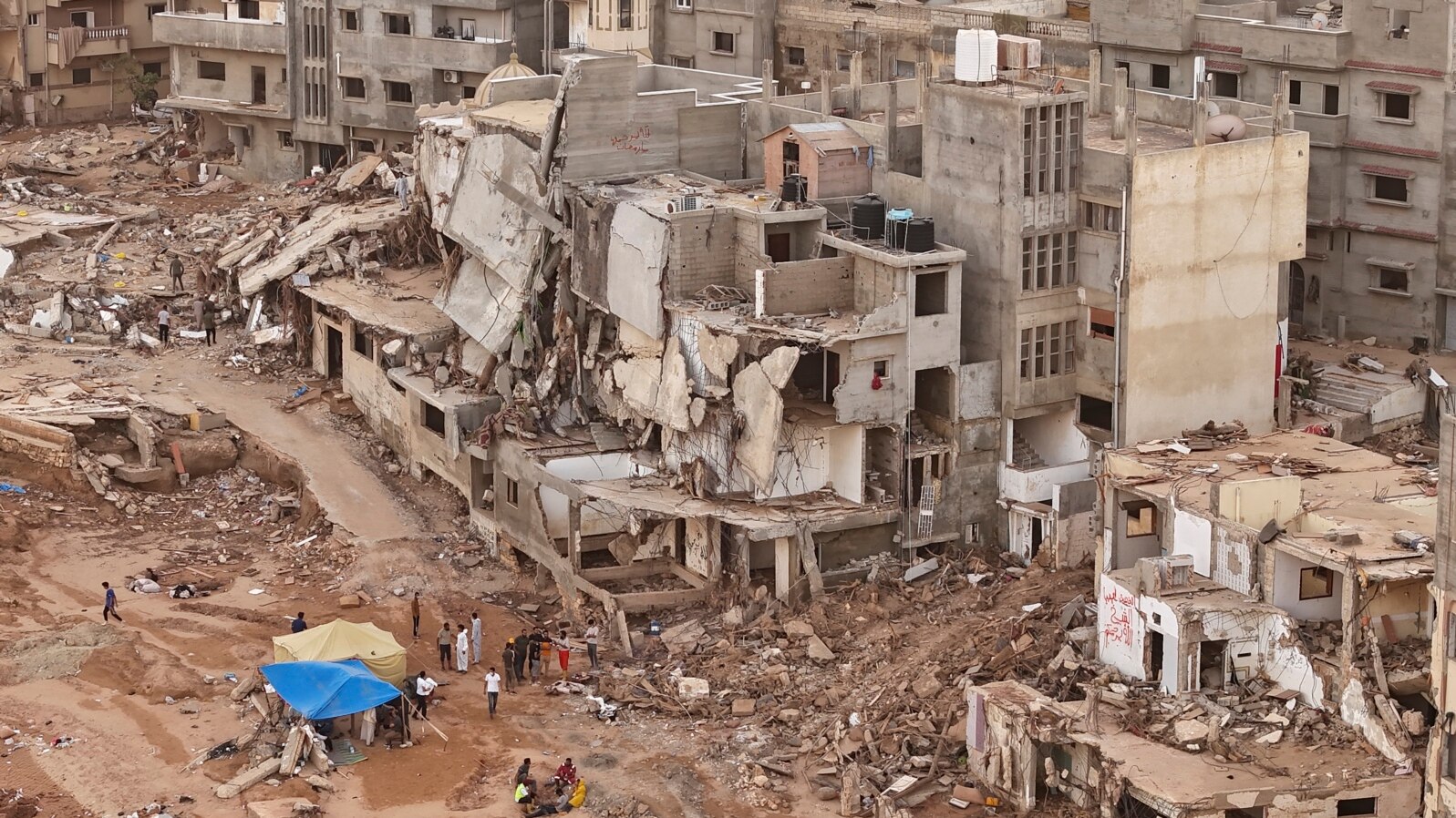 Rescuers and relatives of victims set up tents in front of collapsed buildings in Derna, Libya, Sept. 18, 2023. 