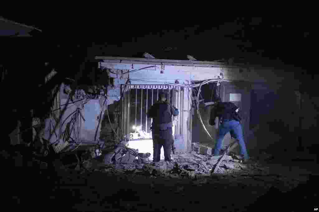 Israeli police check the damage from a rocket fired from the Gaza Strip in Tel Aviv, Oct. 7, 2023.