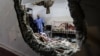 FILE - People inspect the damage in a room following Israeli bombardment at Nasser hospital in Khan Yunis in the southern Gaza Strip on Dec. 17, 2023.