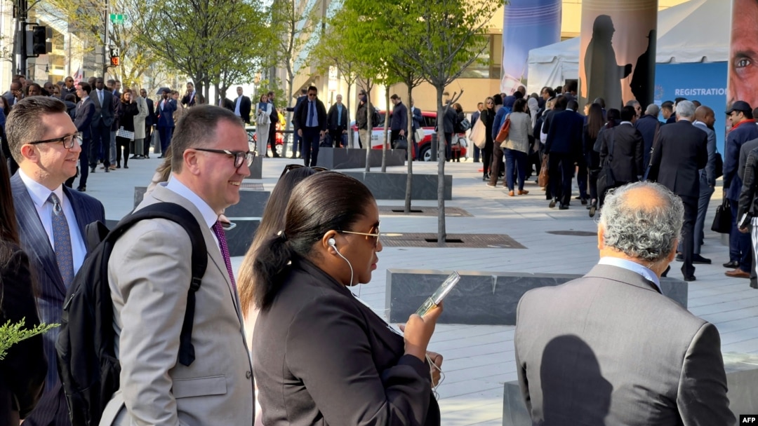 People line up outside the IMF and World Bank spring meeting registration office in Washington, D.C., on April 10, 2023