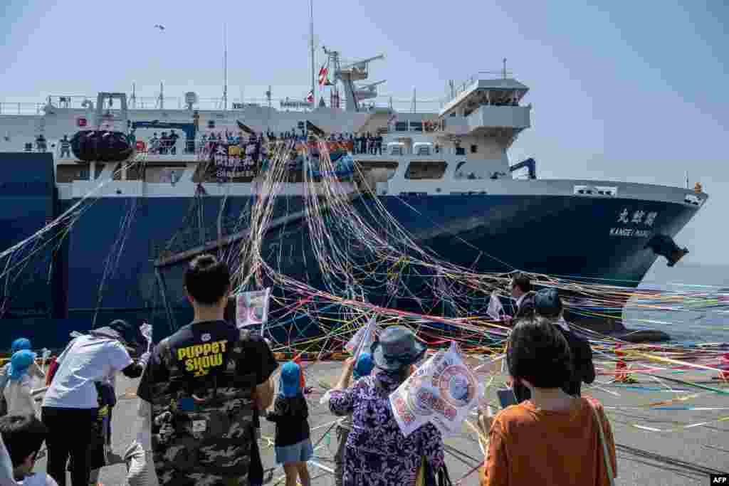 People see off Japan's new whaling mothership, the Kangei Maru, after the ship's launch ceremony at a port in Shimonoseki city, Yamaguchi prefecture. The nearly 9,300-tonne ship set sail on its maiden hunting voyage, heralding a new era for the controversial practice defended by the government as an integral part of national culture.