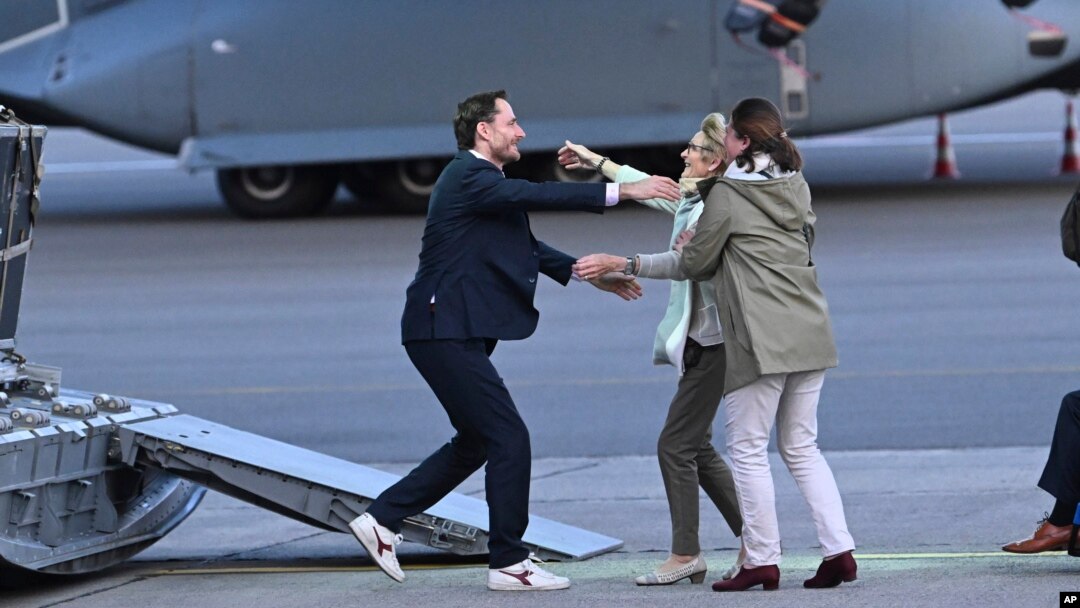 FILE - Belgium's Olivier Vandecasteele, left, is greeted by his family after landing at Melsbroek military airport in Melsbroek, Belgium, May 26, 2023. He was detained in Iran for nearly 15 months.