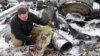 A representative from the prosecutor's office shows parts of an unidentified missile, which Ukrainian authorities believe to have been made in North Korea and used in a strike in Kharkiv earlier this week, Jan. 6, 2024. 