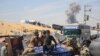Smoke billows following Israeli bombardment as displaced Palestinians move, in Rafah in the southern Gaza Strip, on May 31, 2024.