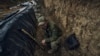 A Ukrainian soldier sits in a trench at the frontline near Bakhmut in the Donetsk region, Ukraine, May 22, 2023. 