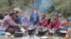 French journalist Vanessa Dougnac, center, sits with nomads in Nepal, 2021. Married to an Indian, Dougnac lived in India for more than two decades before being forced to leave in February 2024 after Indian authorities accused her of writing "malicious" reports.