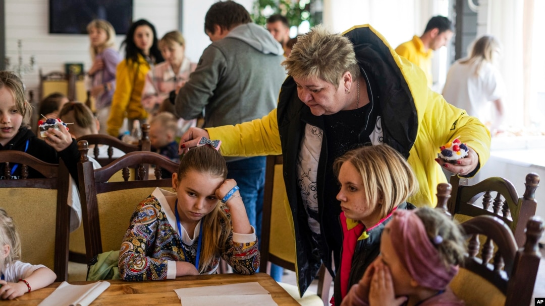 Nina Poliakova speaks to her foster daughter Olha Hinkina at the recovery camp for children and their mothers affected by the war near Lviv, Ukraine, Wednesday, May 3, 2023.