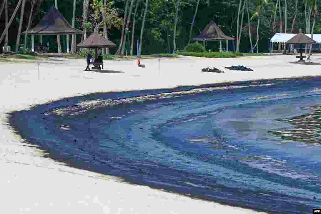 The oil slick is seen washed up on Sentosa island's Tanjong Beach in Singapore.