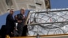 United Nations Secretary-General Antonio Guterres inspects aid for Palestinians, as officials wait to deliver aid to Gaza through the Rafah border crossing between Egypt and the Gaza Strip, at Al Arish airport, in Egypt, Oct. 20, 2023.
