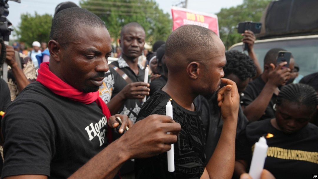 FILE - People light candles during a procession in honor of all protesters killed nationwide at recent economic hardship protests, in Lagos, Nigeria, Aug. 9, 2024. 