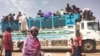 FILE - People board a truck as they leave Khartoum, Sudan, on June 19, 2023. The United Nations Security Council adopted a resolution on March 8, 2024, calling for a Ramadan cease-fire in Sudan.