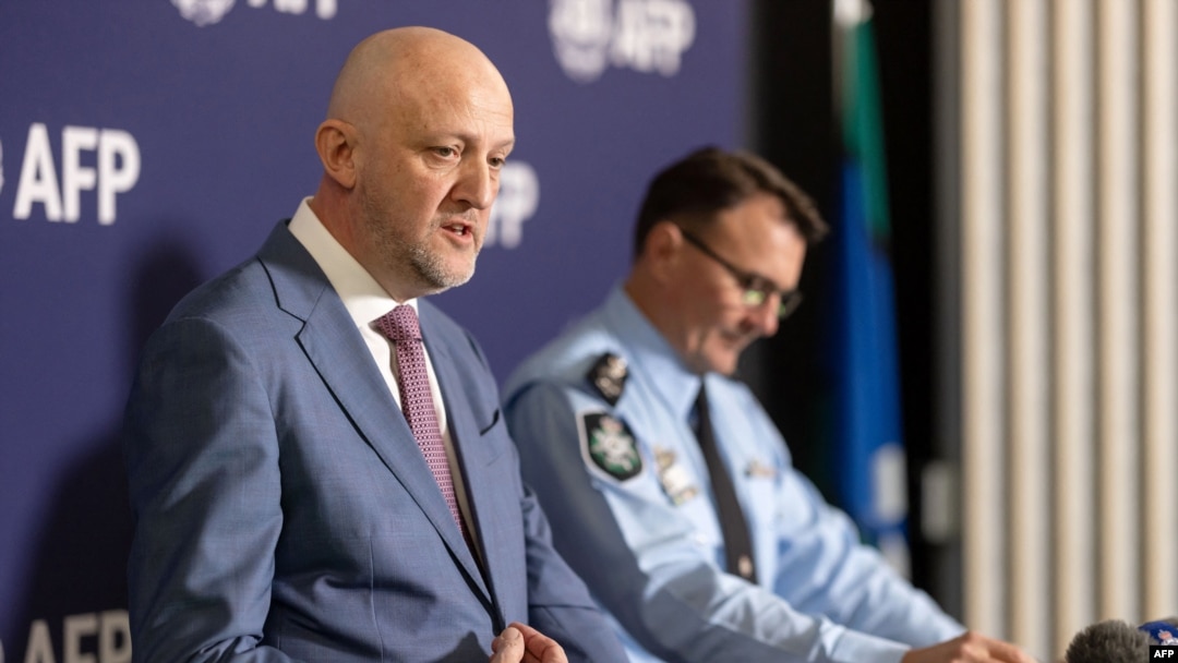 FILE - A handout photo taken on July 12, 2024, and received from the Australian Federal Police shows Australia's Director-General of Security and head of the Australian Security Intelligence Organization Mike Burgess, left, at a news conference in Canberra. 
