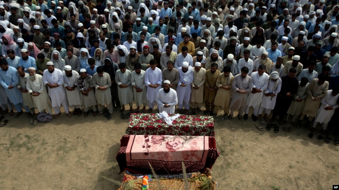FILE - Relatives and mourners attend the funeral prayer of victims who were killed in Sunday's suicide bomber attack in the Bajaur district of Khyber Pakhtunkhwa, Pakistan, July 31, 2023.