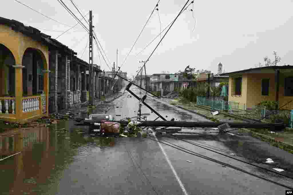 A utility pole lies on the street in Consolacion del Sur, Cuba, after Hurricane Ian made landfall.