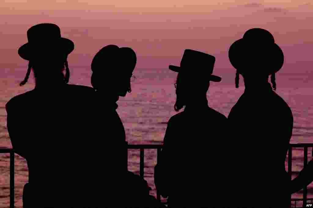 Ultra-Orthodox Jewish men and children perform the "Tashlich" ritual, during which "sins are cast into the water to the fish," ahead of the Day of Atonement, or Yom Kippur, the most important day in the Jewish calendar, which this year will start at sunset on October 4, in the coastal Mediterranean city of Netanya, Israel.