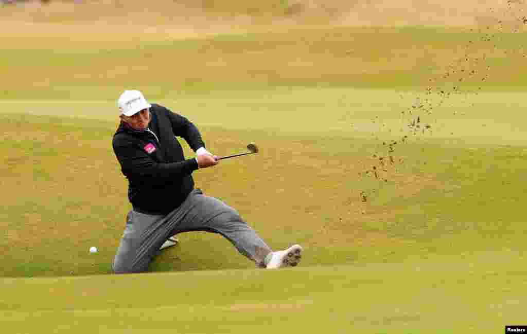 England's Marcus Armitage plays out of a bunker on the 14th during the second round at the 150th Open Championship, in St Andrews, Scotland, Britain.