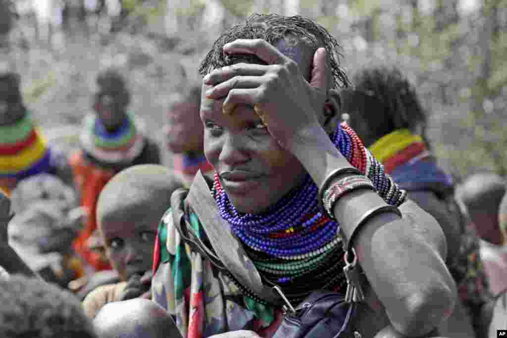 A woman waits for food distribution by the United States Agency for International Development (USAID), in Kachoda, Turkana area, northern Kenya, July 23, 2022.