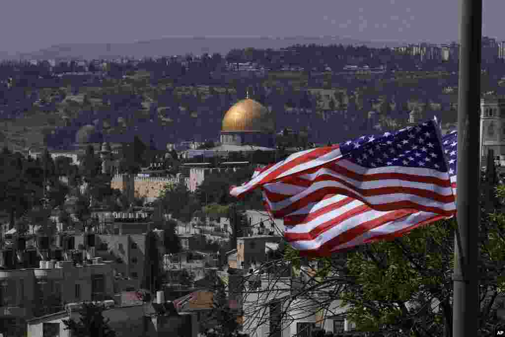 With the Dome of the Rock shrine in the background, U.S. flags fly ahead of a visit by President Joe Biden, in Jerusalem.