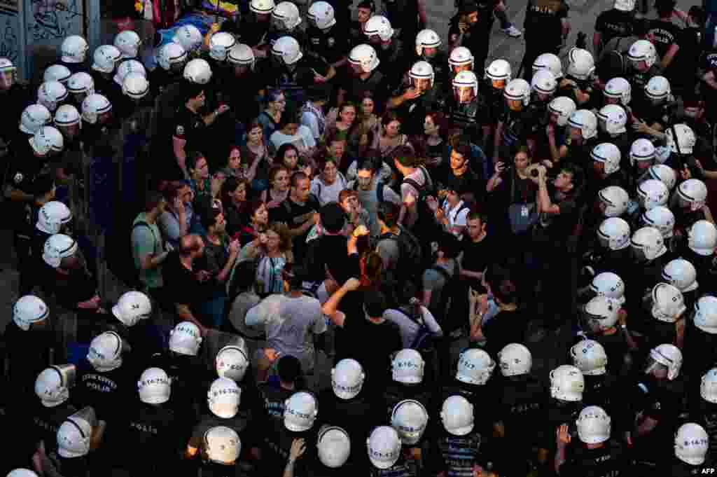 Police officers surround protesters during a rally in the Kadikoy district of Istanbul, Turkey, July 20, 2022, to mark the anniversary of the 2015 suicide attack that took place in the southern Turkish town of Suruc.