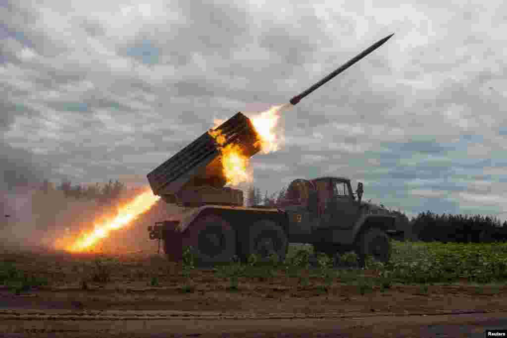 Ukrainian servicemen fire with a BM21 Grad multiple launch rocket system in a frontline in Kharkiv region, as Russia's attack on Ukraine continues.