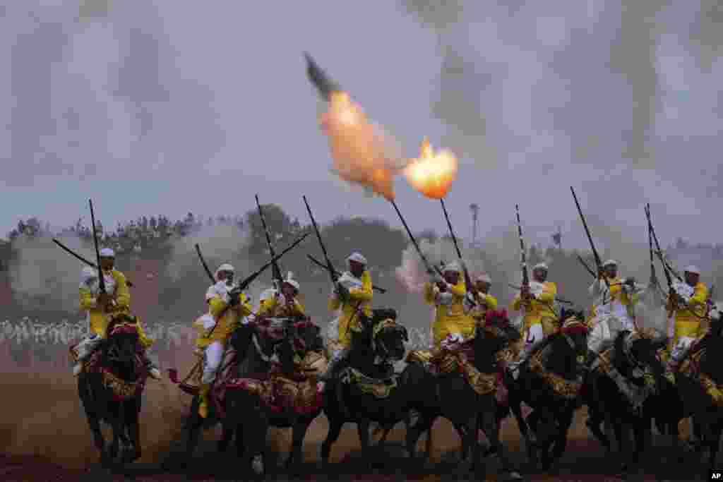 A troupe charges and fires their rifles during Tabourida, a traditional horse riding show also known as Fantasia, in Rabat, Morocco, Aug. 27, 2022.