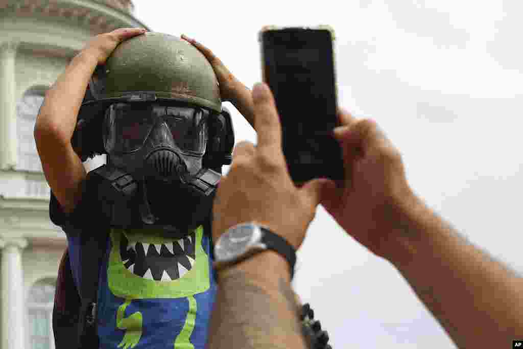 A boy poses for a photo as people attend a military picnic marking the Polish Army Day in Warsaw, Poland.