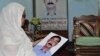 Hajera Khatun holds a photo of her son, opposition Bangladesh Nationalist Party leader Sajedul Islam Shuman, who remains missing after Rapid Action Battalion members allegedly abducted him from Dhaka in 2013. (Abdul Rajjak/VOA)