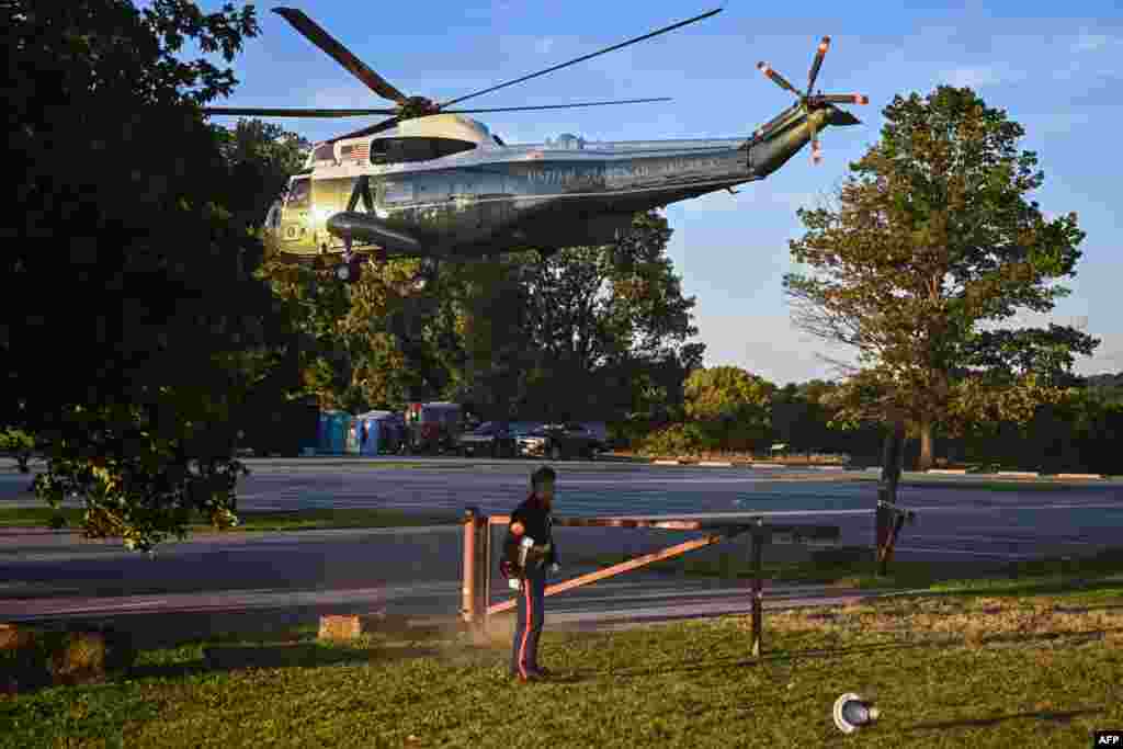 A U.S. Marines' hat is blown off as U.S. President Joe Biden takes off from Brandywine Creek State Park in Marine One in Wilmington, Delaware, Aug. 20, 2022.